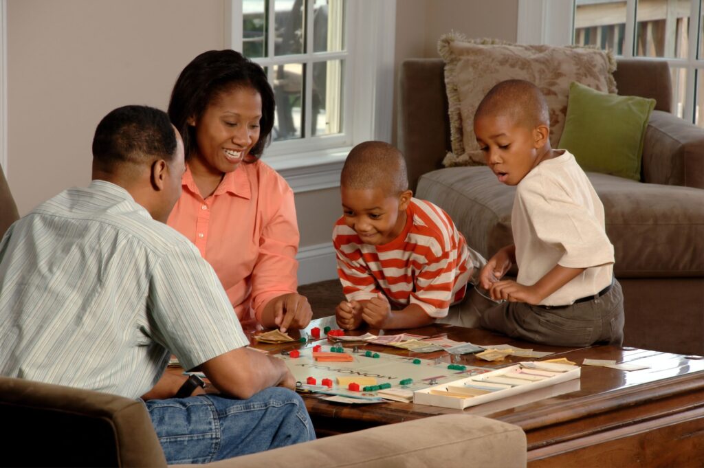 Family playing monopoly together