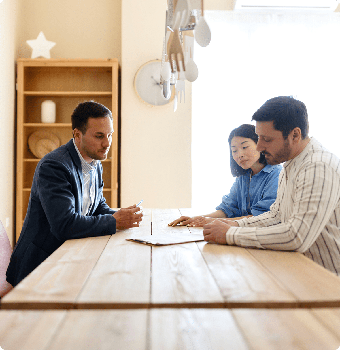 Business discussion around wooden table.
