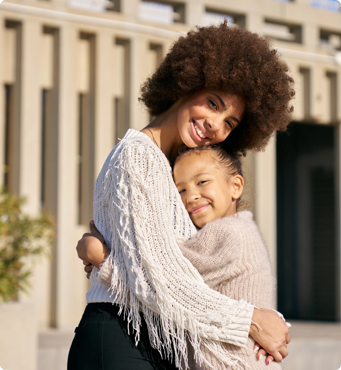 Mother and daughter embracing outdoors