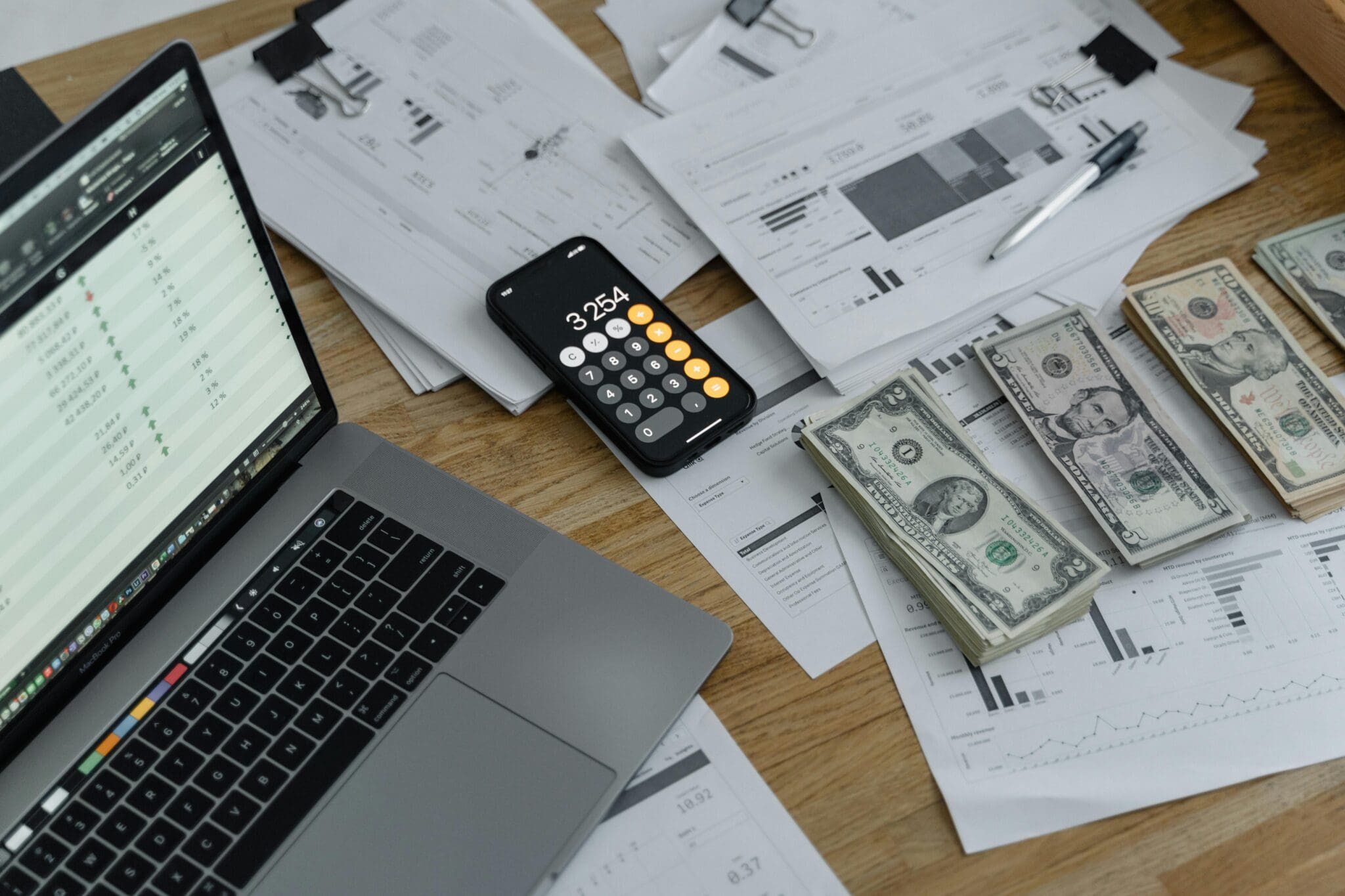 Office desk with reports and currency notes.